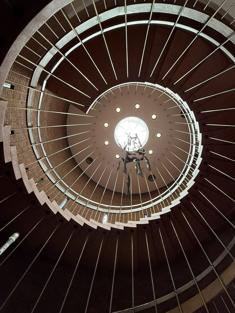 Spiral staircase rising toward the light